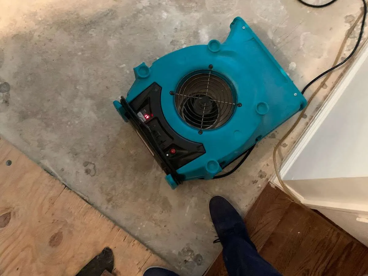 Air mover drying subfloor during Leak Detection & Repair in Harrisville